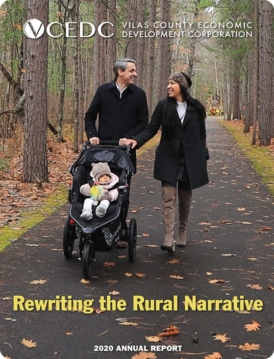 A smiling couple walks on a forest path, pushing a baby in a stroller. The man and woman are warmly dressed. The cover highlights Annual Reports: "Rewriting the Rural Narrative – 2020 Annual Report by Vilas County Economic Development Corporation.